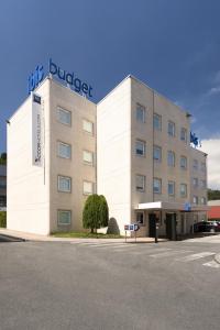 a large white building with a sign on it at Ibis Budget Bilbao Barakaldo in Barakaldo