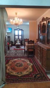 a living room with a chandelier and a rug at Ismailia - Elnouras compound in Ismailia