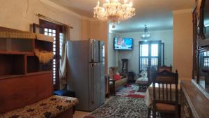 a living room with a refrigerator and a chandelier at Ismailia - Elnouras compound in Ismailia