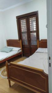 two beds sitting next to each other in a room at Ismailia - Elnouras compound in Ismailia
