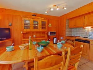 a kitchen with a wooden table with bowls on it at Appartement Les Saisies, 2 pièces, 8 personnes - FR-1-594-41 in Hauteluce