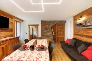 a living room with a couch and a table at Jorasses La Maison de Courma in Courmayeur