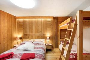 a bedroom with two bunk beds and a ladder at Jorasses La Maison de Courma in Courmayeur