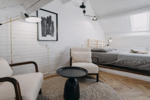 a bedroom with a bed and a chair and a table at CLASSIC JOURNEY duplex centre ville Cholet in Cholet