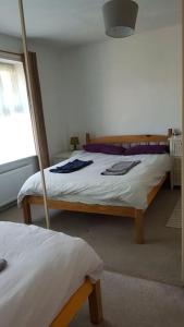 a bedroom with two beds and a window at An oasis of calm next to M'cr City Centre + Parking in Manchester
