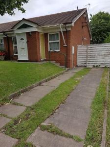 a house with a sidewalk in front of a house at An oasis of calm next to M'cr City Centre + Parking in Manchester