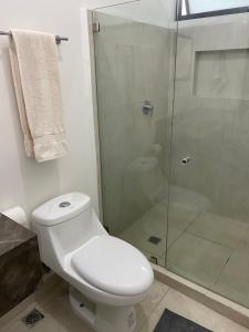 a bathroom with a toilet and a glass shower at SweetHome in Monterrey