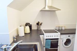 a kitchen with a sink and a stove top oven at Self-contained 1-Bed Apartment in Kirriemuir in Kirriemuir