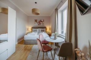 a bedroom with a bed and a table and chairs at Villa SEEhnsucht Ferienwohnungen in Jois