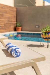 a swimming pool with a blue and white towel at 49 Sunrise Lodge in Għajnsielem