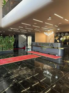 a hotel lobby with a red rug on the floor at Asgard Hotel in Beylikduzu