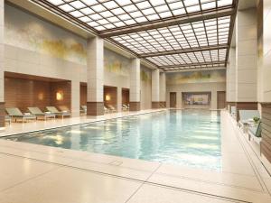a large swimming pool in a building with a ceiling at The Peninsula London in London