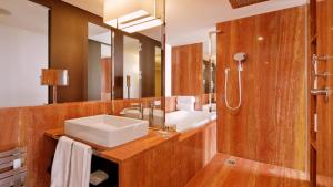 a bathroom with a sink and a mirror at InterContinental Genève by IHG in Geneva