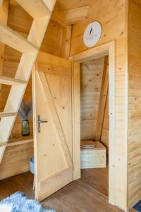 a wooden room with a door and a clock at Diamond Cabin Orava in Párnica