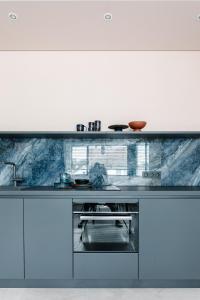 a kitchen with a stainless steel counter top at Exklusive Design Appartement Deep Blue Neubau in Pfungstadt
