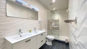 a bathroom with a sink and a toilet and a shower at Hotel Le Florian in Cannes