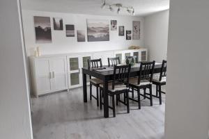 a dining room with a black table and chairs at Ferienhaus Chester in Naumburg