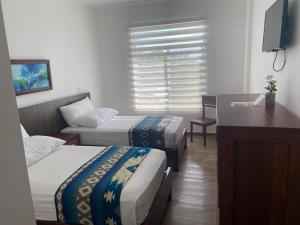 Postel nebo postele na pokoji v ubytování La Bocana de Quiximies Hotel