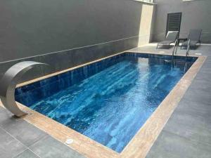 a swimming pool with blue water in a building at Rose 6 Comfort living at Cleopatra in Alanya
