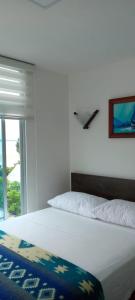 Postel nebo postele na pokoji v ubytování La Bocana de Quiximies Hotel