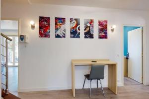 a desk with a chair and a painting on a wall at 11.Studio#Creteil#Loft#Cinéma in Créteil