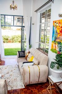 a living room with a couch and a painting at Kathy's Two Bedrooms in Nairobi