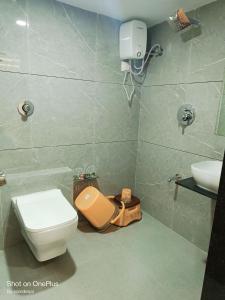 a bathroom with a toilet and a sink at HOTEL ROYAL GRAND in Ahmedabad