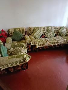 ein Sofa mit Kissen darauf im Zimmer in der Unterkunft Banraplang syngkrem house in Shillong