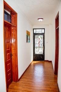 an empty hallway with a door and a window at Kathy's Two Bedrooms in Nairobi