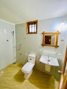 a bathroom with a toilet and a sink at Thought Blooming in Udawalawe