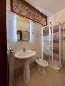 a bathroom with a sink and a shower and a toilet at Nel cuore del centro storico in Cuneo