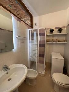 La salle de bains est pourvue de toilettes, d'un lavabo et d'une douche. dans l'établissement Nel cuore del centro storico, à Coni
