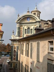 Un vieux bâtiment avec une tour d'horloge en haut dans l'établissement Nel cuore del centro storico, à Coni