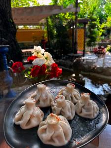 a plate of dumplings on a table at Qafqaz Fountain Villa in Gabala