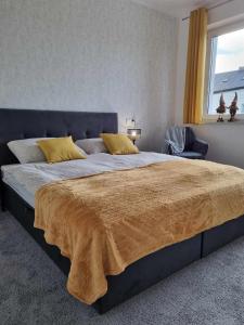 A bed or beds in a room at Domek pod świerkami -Apartament świerkowy IV