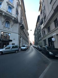 a street with cars parked on the side of a building at Dolce Vita House in Budapest