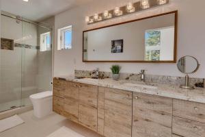 a bathroom with a sink and a toilet and a mirror at Palisades Tahoe Mountain Oasis in Olympic Valley +29 photos