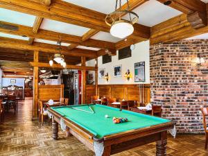 a pool table in a room with a brick wall at Krupówki 40 in Zakopane