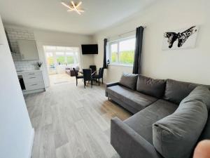 a living room with a couch and a table at 2 bedroom holiday home in the heart of west wales in St Clears