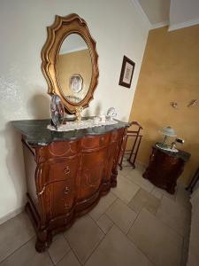 a bathroom with a dresser with a mirror on it at CASA STALLONE in Bari