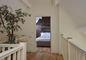 a bedroom with a bed in the middle of a room at The Old Barn at Moor Farm in Godshill