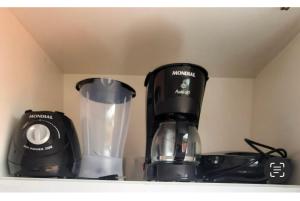 a coffee maker and a blender sitting on a shelf at Apê Serrano in Serra de São Bento