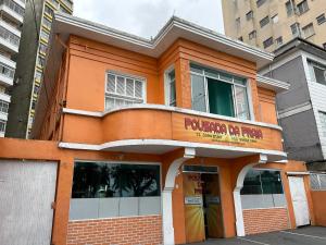 an orange building with a rickenbacker ranch sign on it at Pousada da Praia in São Vicente