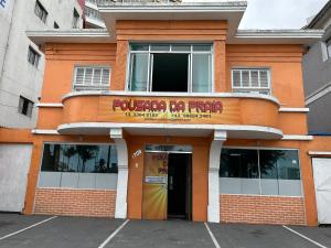 a building with a sign on the front of it at Pousada da Praia in São Vicente