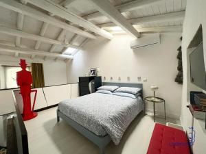 a bedroom with a bed in a white room at La dimoro in Randazzo