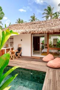 a villa with a pool and a resort with a thatched roof at Manao Villas in General Luna