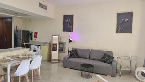 - un salon avec un canapé et une table dans l'établissement Full Sea view studio, à Ras al Khaimah