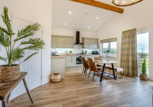 a kitchen and dining room with a table and chairs at The Heritage Retreat in Monknash