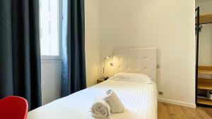 Postel nebo postele na pokoji v ubytování Hotel Le Florian