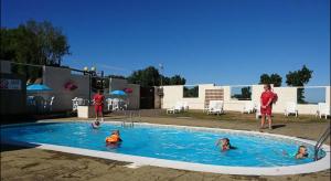 a group of people in a swimming pool at 2 Bedroom Caravan With Sea Views in Eastchurch